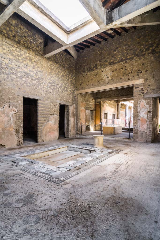 VI.8.3/5 Pompeii. April 2022.
Looking north-west across impluvium towards rooms on west side of atrium and tablinum.
Photo courtesy of Johannes Eber.