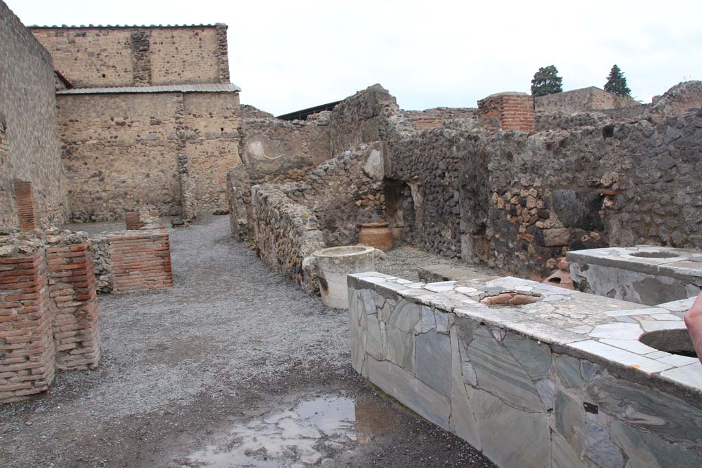 VI.8.8 Pompeii. April 2014. Looking north along east side towards room at rear behind marble counter/podium.
Photo courtesy of Klaus Heese.