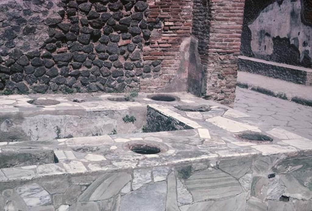 VI.8.8, Pompeii. August 1965. Looking south-east across the counter, on the opposite side of the Via delle Terme can be seen a bench outside the Forum Baths. Photo courtesy of Rick Bauer.