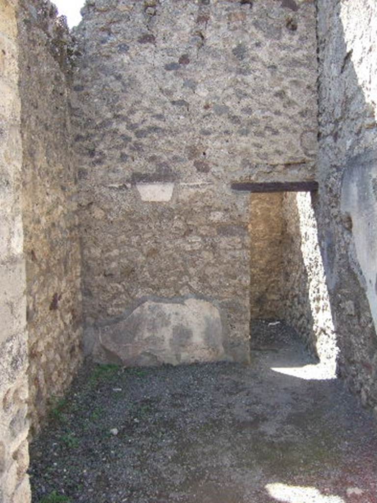 VI.8.14 May 2006. Looking west across entrance room.  According to Mau, there used to be a brick bench on the right, with the two niches above it. In the middle was a block of limestone, which may have been used as an altar. At the rear is a door leading into a small back room.  This chapel was formerly thought to be a barber shop.
See Mau, A., 1907, translated by Kelsey, F. W., Pompeii: Its Life and Art. New York: Macmillan. (p. 235).
