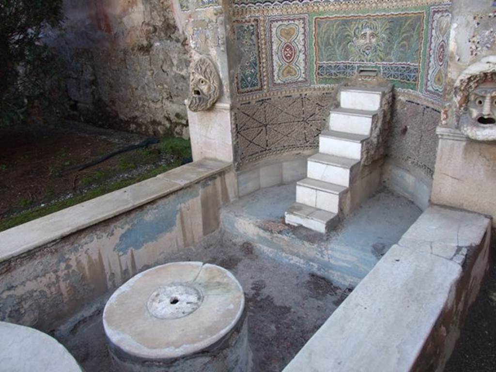 VI.8.22 Pompeii. March 2009. Large fountain. Centre panel of a mask of a river god surrounded by plants. Underneath is the opening for the water which then fell down the marble steps into the pool below.