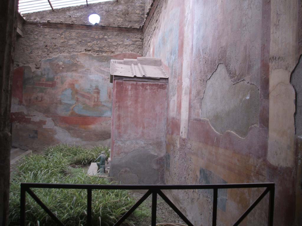 VI.8.23 Pompeii. May 2005. Looking south along the west wall behind the fountain.
