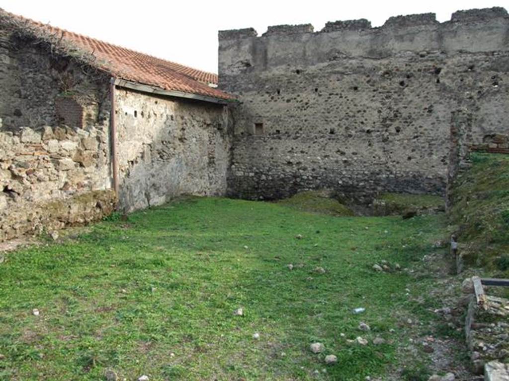 VI.9.1 Pompeii. December 2007. Looking south.
According to Jashemski, this area was the site of the spacious L-shaped garden of the Hospitium, room 18. It was excavated in 1830. On the west side of the garden was an exceptionally large triclinium, room 15, with windows onto the garden area. Remains of the wall with windows can be seen on the right of the photo.
See Jashemski, W. F., 1993. The Gardens of Pompeii, Volume II: Appendices. New York: Caratzas. (p.137)
According to Warscher, quoting Minervini in Bull. Napol. 1843, p.69, she described –
“The open space of which we have already spoken, and to which one exits from the last described cubiculum, was perhaps used as a garden, and onto which opened three large windows, one of which was from the already described cubiculum, and two were in the walls of the big room, (the large triclinium) as we have said, to the right of the atrium. A masonry channel collected water that fell from the roof and carried it into a cistern, of which one could see the double mouth. Also in the wall in front of this garden were more windows intended to give light to a workshop at the back of the garden, of this same, we must investigate further. Behind the already described channel was a spacious room in which we could see other cistern openings, however with whitewashed masonry and a black zoccolo. This room certainly supported the roof slope towards that channel: this room communicated with the atrium, and also had a doorway, which now could be seen walled up, with another room ... ...”
See Warscher, T, 1938: Codex Topographicus Pompejanus, Regio VI, insula 9: Pars prima, (see photographs nos: 21, 22 and 23), Rome, DAIR, whose copyright they remain.
