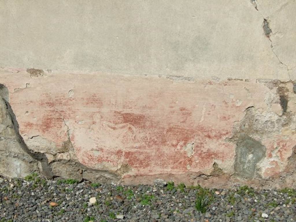 VI.9.2 Pompeii. March 2009. Peristyle 16. North wall. Detail of painted plaster with remains of figure.
