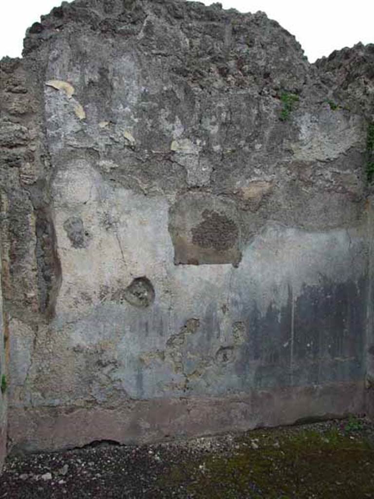 VI.9.2 Pompeii. May 2010. Room 13, east wall. According to PPM, this wall showed a red zoccolo at its base. The middle zone of the wall had a central aedicula and side panels. The central panel had a painting, now removed.