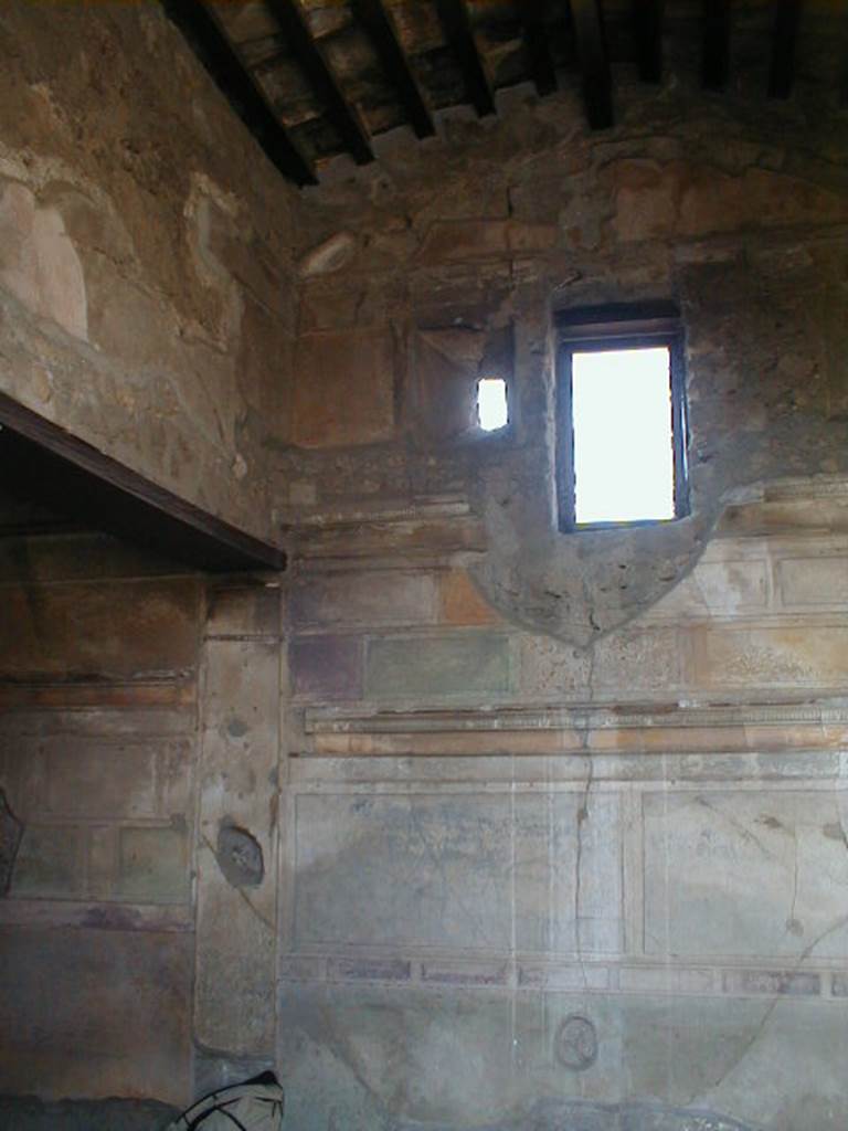 VI.9.3 Pompeii. September 2004. Cubiculum3, on south side of entrance doorway. Looking towards the south-west corner with alcove for the bed. The small original window, partly blocked, can be seen to the left of the modern window. See Mau, A., 1907, translated by Kelsey, F. W., Pompeii: Its Life and Art. New York: Macmillan. (p. 261-2, and Fig.122)