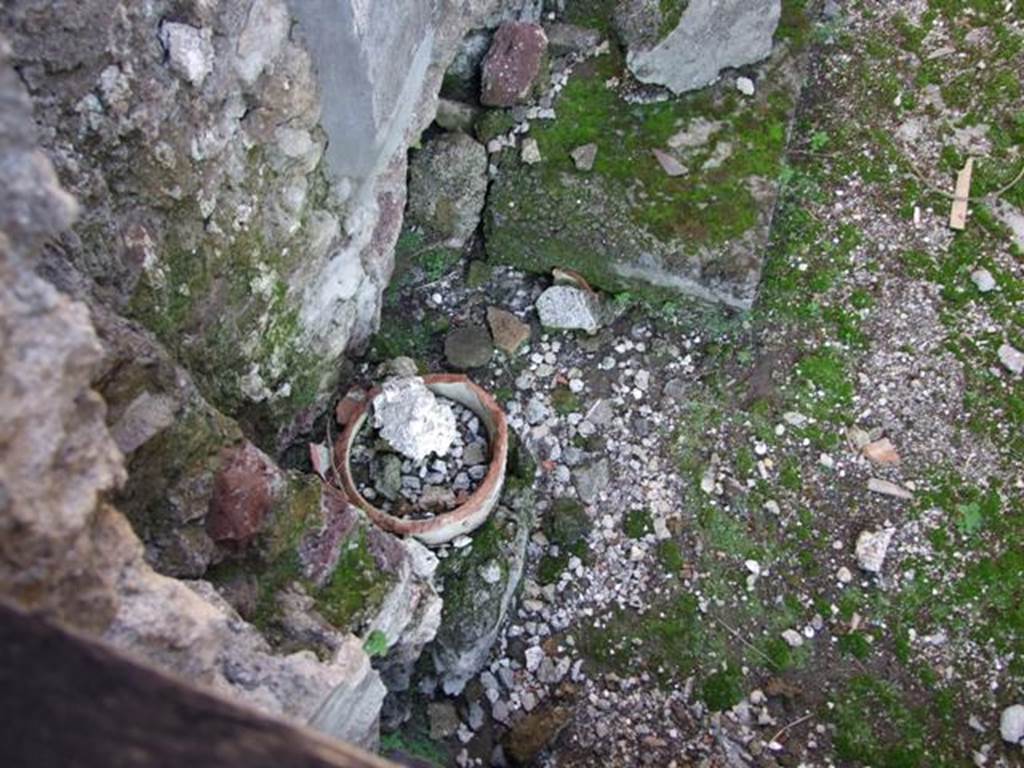 VI.9.4 Pompeii. December 2007. Remains of a terracotta down-pipe from the upper floor rooms in north-west corner of room15 below.