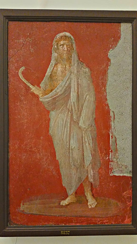 VI.9.6 Pompeii. Wall painting of Saturn or Chronos or Chronus holding a sickle.
One of two paintings that flanked the door in the deep bay of the atrium that formed a vestibule for the peristyle.
Now in Naples Archaeological Museum. Inventory number 8837.
Photo courtesy of Giuseppe Ciaramella, November 2018.