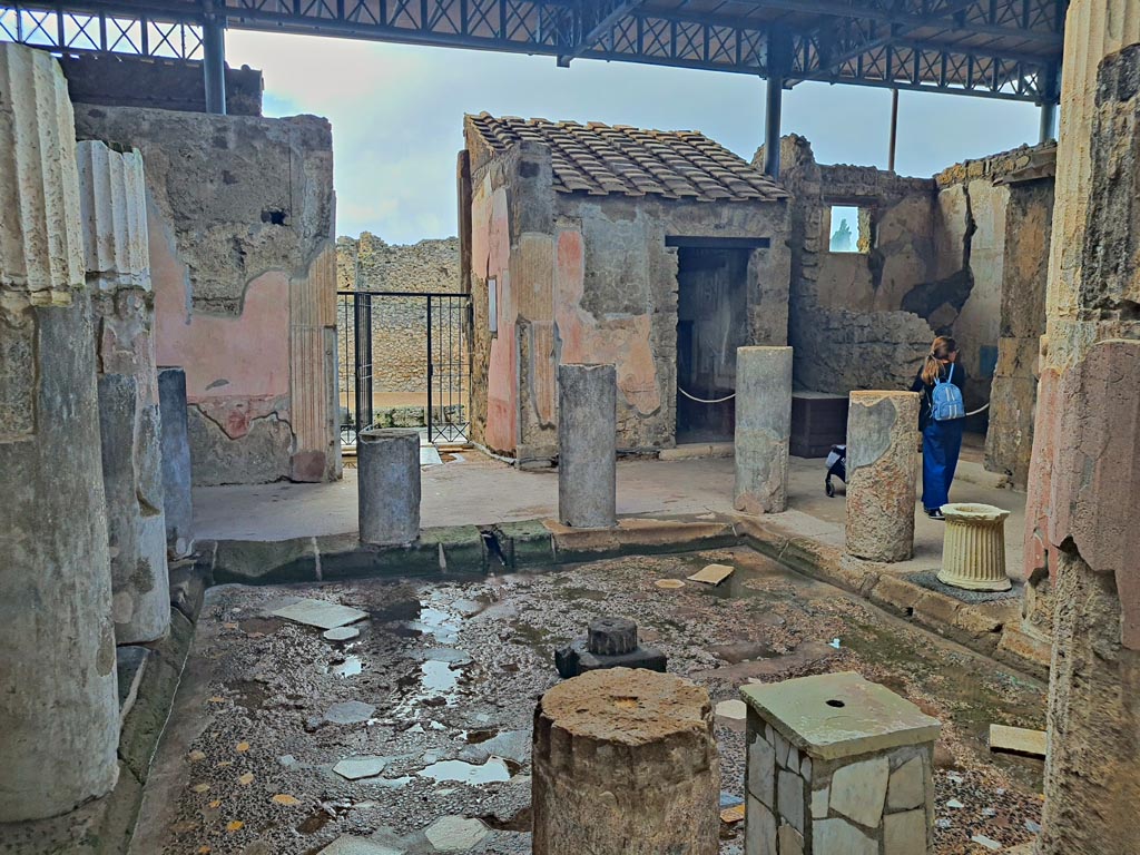 VI.9.6 Pompeii. November 2023.
Room 3, looking west across impluvium in atrium from outside room 9, tablinum. Photo courtesy of Giuseppe Ciaramella.