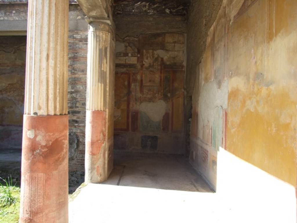 VI.9.6 Pompeii. March 2009. Room 6, looking west into north-west corner of peristyle. On the right, on the north wall in the yellow panel, the remains of the painted figure below, can just be seen.