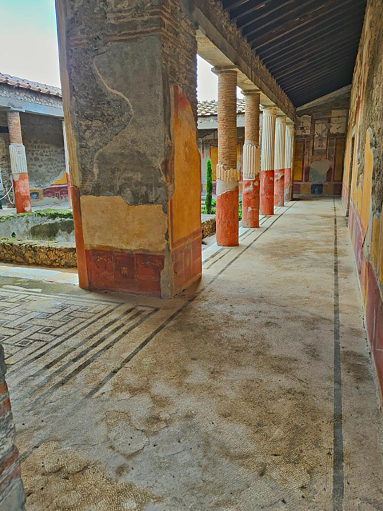 VI.9.6 Pompeii. November 2023.
Room 6, looking west towards pilaster in north-east corner of peristyle, and along north portico.
Photo courtesy of Giuseppe Ciaramella.