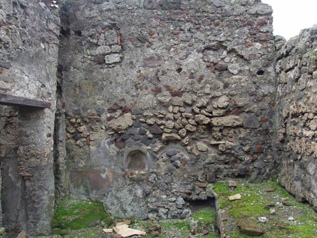 VI.9.6 Pompeii. March 2009. Room 18, west wall with small arched niche, in kitchen and latrine. According to Boyce, a fragmentary painting of Fortuna holding a rudder upon a globe, and below her, the two serpents and an altar, was reported to have been found in the kitchen. No trace of the painting exists now. See Boyce G. K., 1937. Corpus of the Lararia of Pompeii. Rome: MAAR 14. (p.50, 177B).