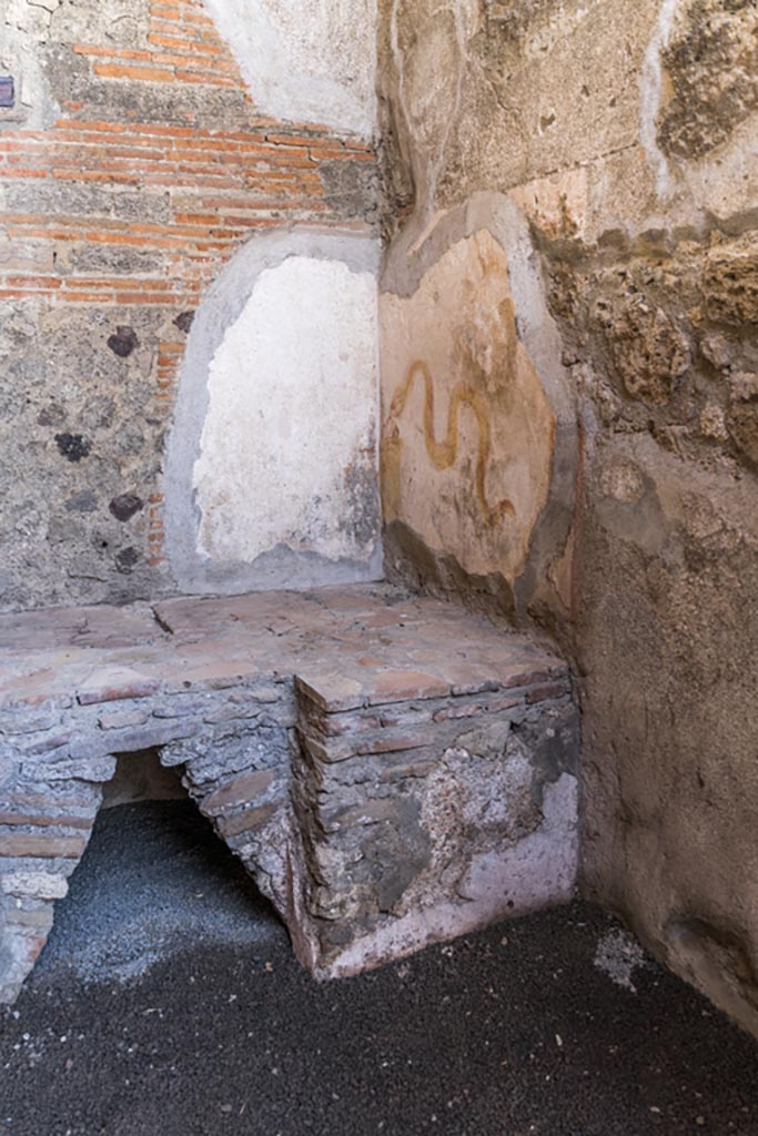VI.9.7 Pompeii. January 2023.
Room 4, north-west corner with hearth and painted lararium on the north wall of the kitchen.
Photo courtesy of Johannes Eber.