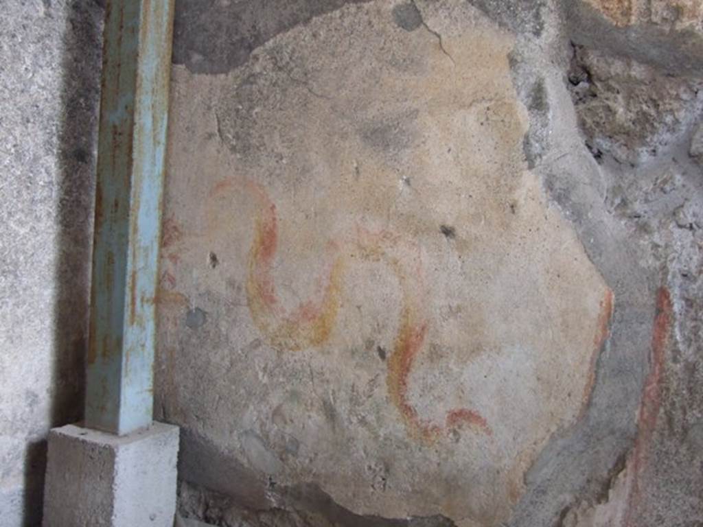 VI.9.7 Pompeii. March 2009. Room 4, painted lararium on north wall, in north-west corner of kitchen. According to Boyce, in the north-west corner above the hearth is a painting of two red and yellow serpents. The one on the right has red crest and beard; the head of the other is destroyed.
They approach an altar. There are garlands above. See Boyce G. K., 1937. Corpus of the Lararia of Pompeii. Rome: MAAR 14. (p.50, 178)