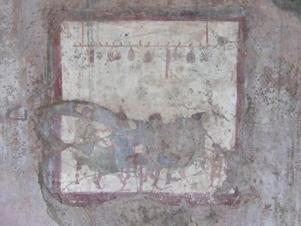 VI.10.1 Pompeii. March 2009. Fresco on south wall of rear room on north side. People at a table with sausages, onions and other food hanging above them.