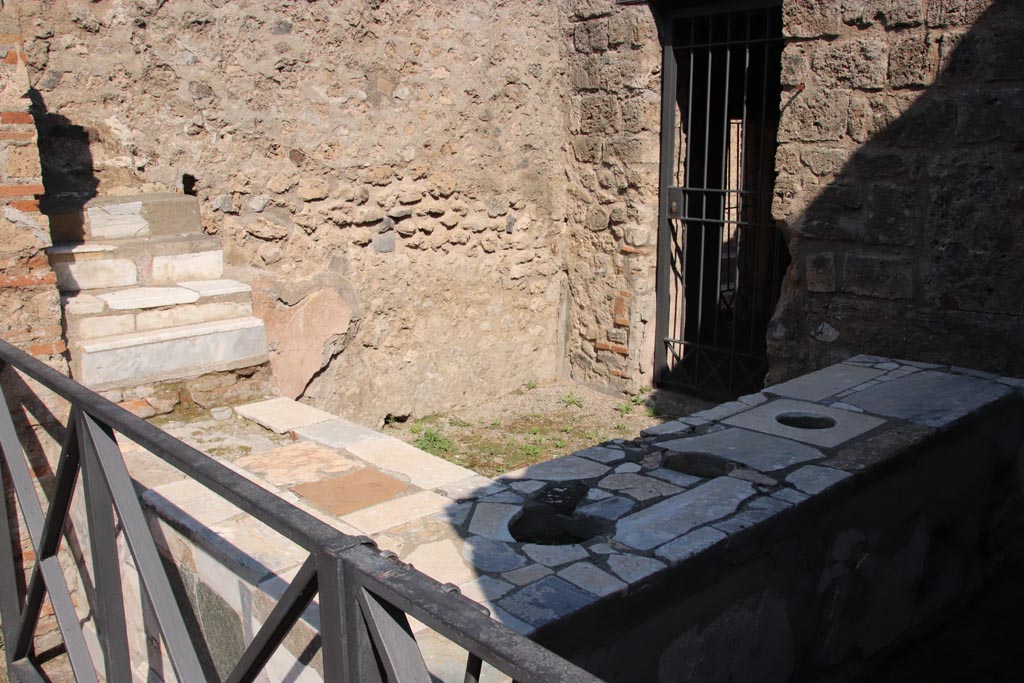 VI.10.1 Pompeii. October 2022.
Looking north-east across bar-room, with display shelving, in upper left. Photo courtesy of Klaus Heese.