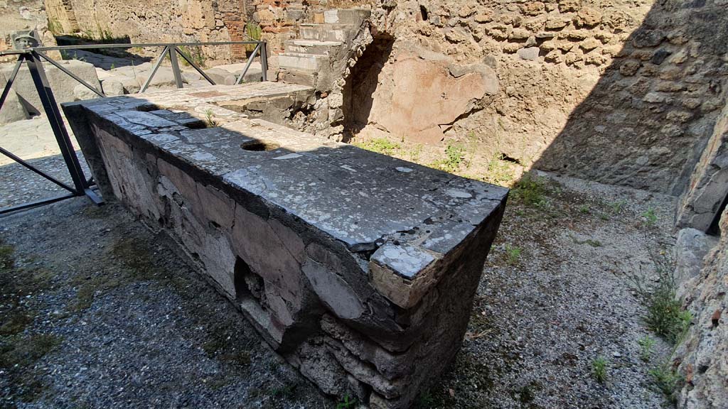 VI.10.1 Pompeii. July 2021.
Looking north-west across counter with three inset urns, towards display shelving and recess in north-west corner of bar-room.
On the left, on the other side of Via di Mercurio, is the fountain of Mercury outside VI.8.24.
Foto Annette Haug, ERC Grant 681269 DÉCOR.