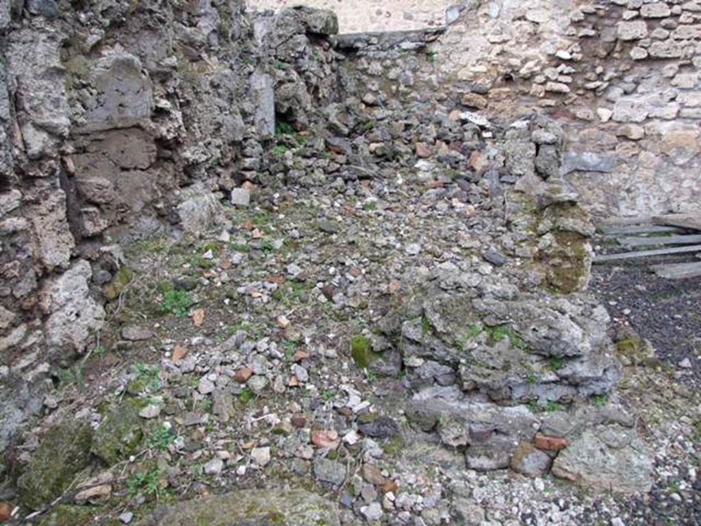 VI.10.2 Pompeii. March 2009. Remains of room to east of oecus, this would have been the first room on the left of the peristyle. According to Garcia y Garcia, on 13th September 1943 at 5 in the evening, a huge bomb fell on the north-east section of the house. This caused the total ruin of three rooms with the total loss of all paintings and wall plaster and stucco.
The north-east and east perimeter walls were also destroyed. See Garcia y Garcia, L., 2006. Danni di guerra a Pompei. Rome: L’Erma di Bretschneider. (p.80, and figs 150-153)