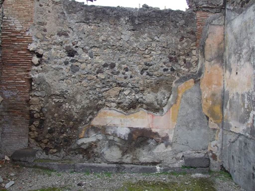 VI.10.11 Pompeii. March 2009. Room 8, north wall of tablinum. The tablinum was found with a large threshold of lava below a walled-up doorway. The middle zone of the wall had been painted with yellow panels separated by red partitions. In the centre of the north wall, the black predella was found with painted seahorses and green dolphins.
See Bragantini, de Vos, Badoni, 1983. Pitture e Pavimenti di Pompei, Parte 2. Rome: ICCD. (p.235, tablino 15)