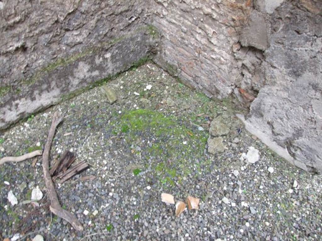 VI.10.11 Pompeii. March 2009. Room 16, north-west corner of oecus/triclinium. According to Costantino, this room was a triclinium and would have had a floor of opus sectile containing slabs of marble which would have been the same as in the zoccolo. These were not present, perhaps they had been removed prior to the eruption and had not yet been re-applied. The preparation for their insertion again could be seen in the north-west corner of the room. The IVth style decoration was preserved only on the east and west walls of the room. The north and south walls contained two vast doorway entrances, which took up most of their walls.
See Costantino, C: L’apparato decorativo, in Rileggere Pompei, L’insula 10 della Regio VI, (2006), ed by Coarelli and Pesando, Rome: L”Erma” di Bretschneider, (p.299)