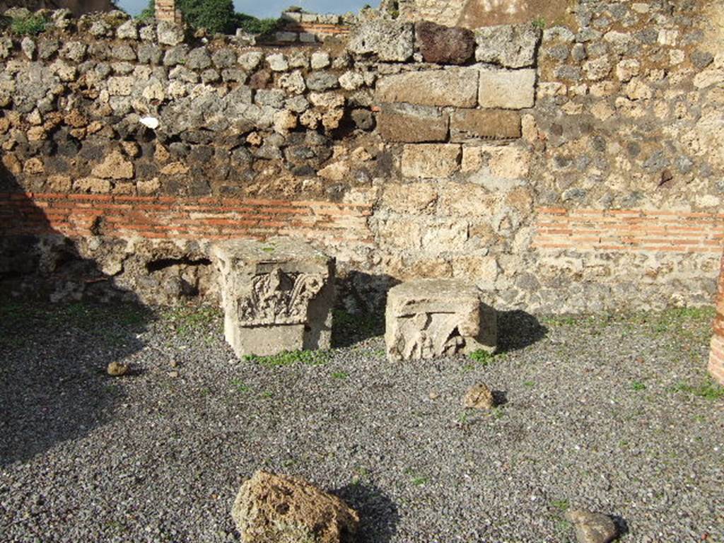 VI.10.15 Pompeii. December 2005. Two tufa capitals. These capitals were lodged here for safety, they most probably topped the pilasters of the vestibule of VI.10.14.
See Studi della Soprintendenza archeologica di Pompei, 12, (2006): Rileggere Pompei, I. L’insula 10 della Regio VI, ed by Coarelli and Pesando, Rome, “L’Erma” di Bretschneider, (p.345)
