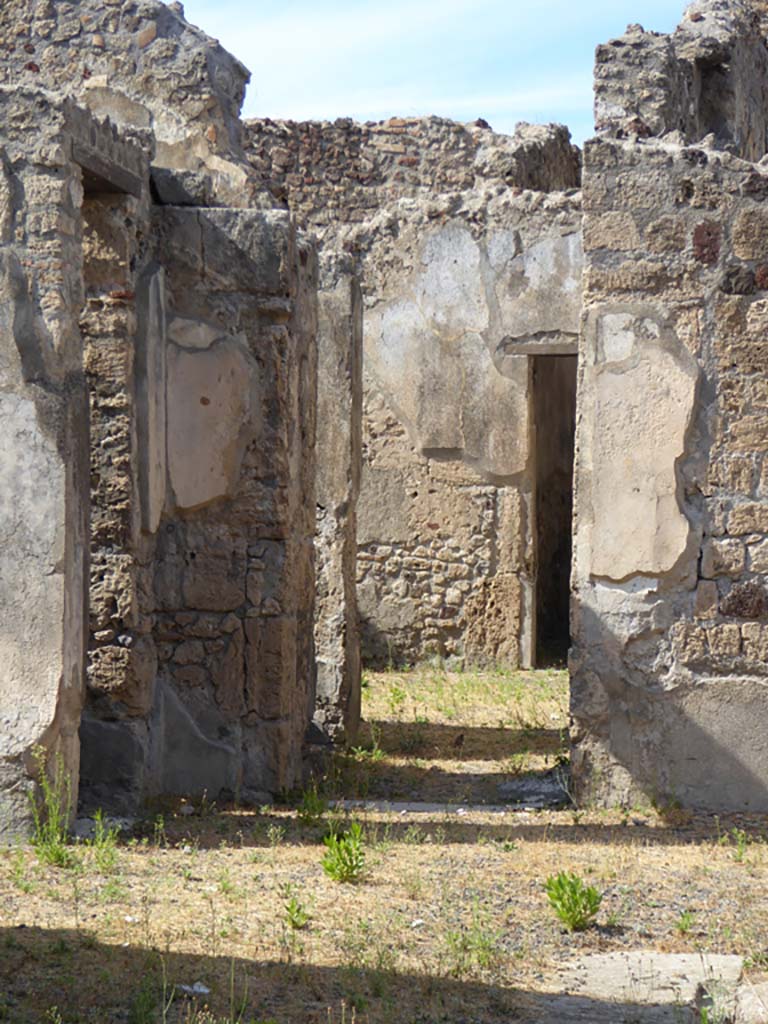 VI.11.9 Pompeii. November 2017.
Looking north in north-west corner of atrium 3, with doorway to room 8, on left.
In the centre is the doorway into the corridor 15 at the base of the stairs 9.