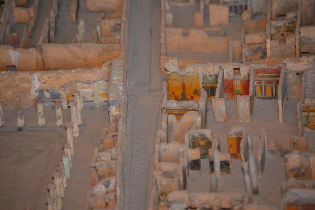 VI.11.9/10 Pompeii. July 2017. Looking west along Vicolo del Mercurio, with VI.12, House of the Faun, on left.
On the right is the south-west corner of atrium 3 (of VI.11.9), with the west wall of the entrance corridor, just visible.
In the corner is the west wall of room 5, with room 4 next to it.
The doorway to room 6 leads into the room with red/yellow/green west wall, followed by west ala 7.
Room 8, the area under the stairs, is the undecorated area next to it.
From cork model in Naples Archaeological Museum.
Foto Annette Haug, ERC Grant 681269 DÉCOR.