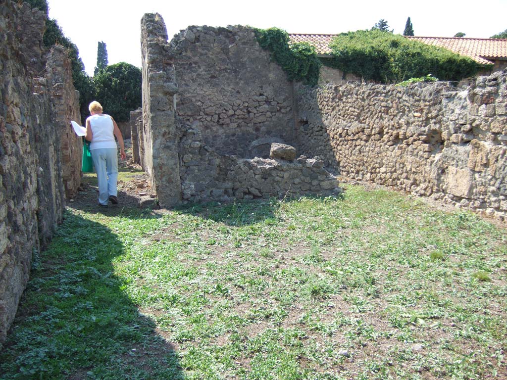 VI.11.13 Pompeii. September 2005. Looking west across open area, on the right in which there is a cistern head.
The corridor ahead would have led to VI.11.6.
