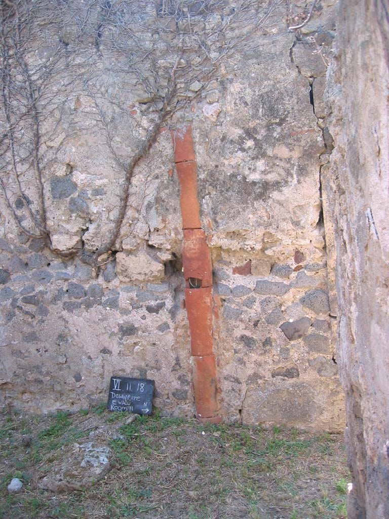 VI.11.19 Pompeii. July 2008. Looking towards downpipe in west wall. Photo courtesy of Barry Hobson.