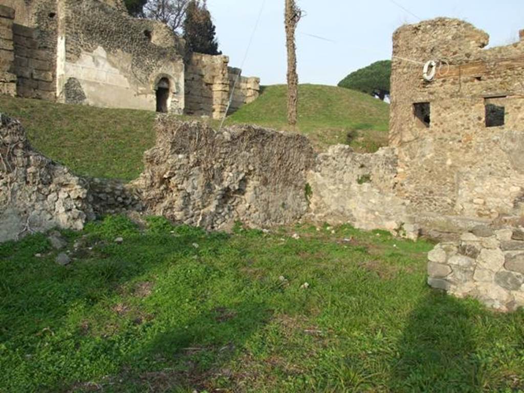 VI.11.20 Pompeii. December 2007. Ruined area of shop in north-east corner of insula, taken from atrium of VI.11.19. On the right, can be seen the remains of the entrance doorway into the vicolo, between the two windows on the opposite side of the vicolo.