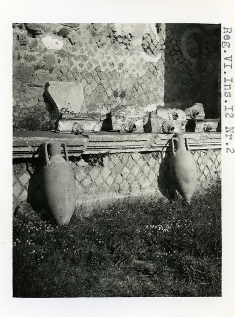 VI.12.2 Pompeii. Pre-1937-39. Amphorae and water-spouts on display, on north side of rear peristyle.
Photo courtesy of American Academy in Rome, Photographic Archive. Warsher collection no. 36.