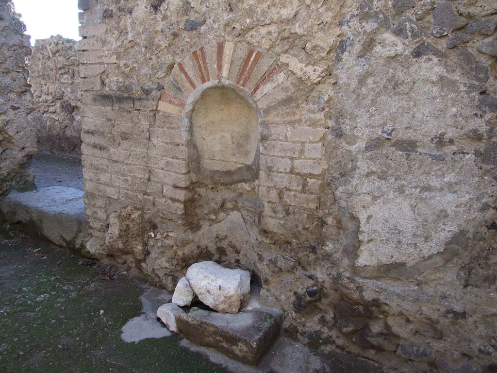 VI.12.2 Pompeii. December 2006. Niche on west wall of kitchen, with doorway to Corridor 19, on left.
(PPM – room 24)
