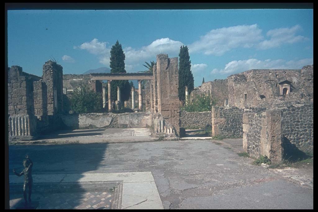 VI.12.2 Pompeii. Looking north across east side of atrium.
Photographed 1970-79 by Günther Einhorn, picture courtesy of his son Ralf Einhorn.
According to Garcia y Garcia, two bombs fell on this house in 1943.
One caused the destruction of three rooms to the north-east of the Tuscanic atrium, then causing damage to other areas.
The loss of 1st style painting on the north and east walls of the atrium, and on the dividing wall of two cubicula to the west of these.
The mosaic floor was also damaged.
In a cubiculum in the south-east of the atrium, there was a total loss of the 2nd style painting.
In the other two cubicula on the east side, there was a total loss of the 1st and 4th style decoration.
The floor of the centre of the atrium also suffered damage.
The other bomb fell on the secondary atrium, see VI.12.5.
See Garcia y Garcia, L., 2006. Danni di guerra a Pompei. Rome: L’Erma di Bretschneider. (p.82-85, with photos)
