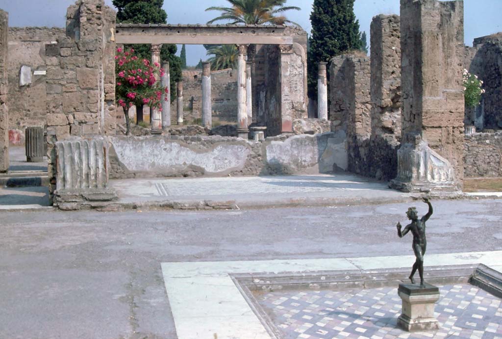 VI.12.2 Pompeii, August 1976.
Looking north from impluvium in atrium, through tablinum across middle/first peristyle towards exedra and rear/second peristyle.
Photo courtesy of Rick Bauer, from Dr George Fay’s slides collection.