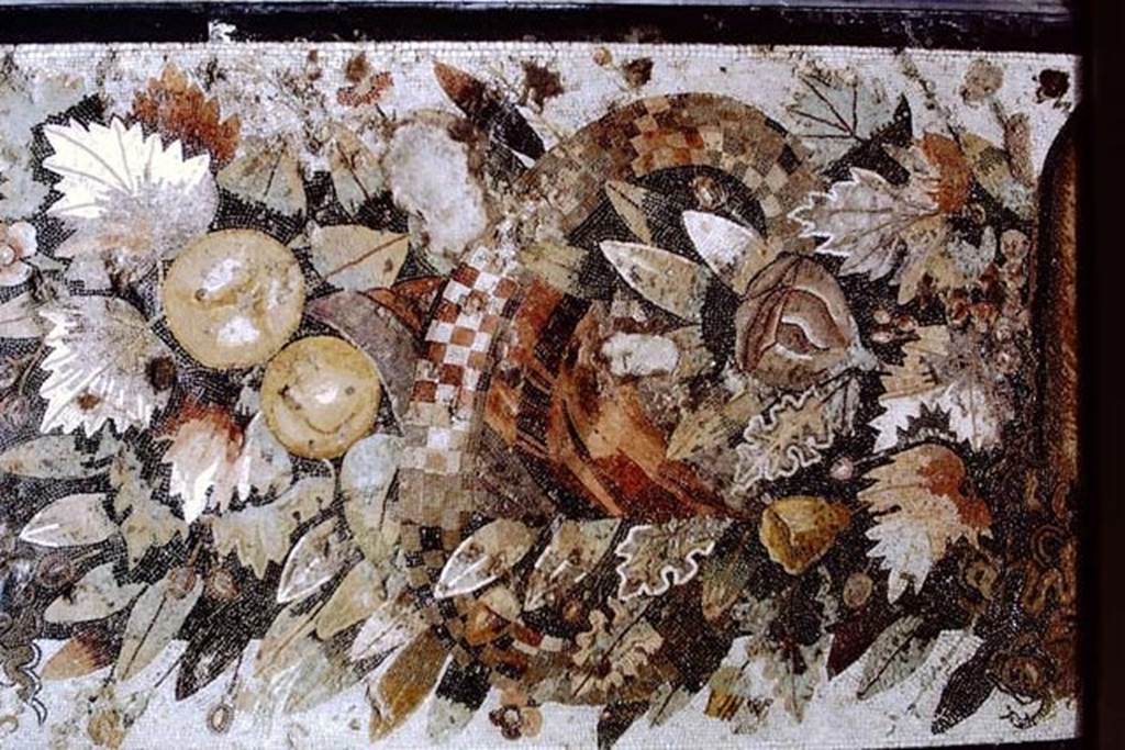 VI.12.2 Pompeii. 1968. Detail from centre of mosaic of fruits, flowers and garlands and two tragic masks.
Photo by Stanley A. Jashemski.
Source: The Wilhelmina and Stanley A. Jashemski archive in the University of Maryland Library, Special Collections (See collection page) and made available under the Creative Commons Attribution-Non Commercial License v.4. See Licence and use details.
J68f1037