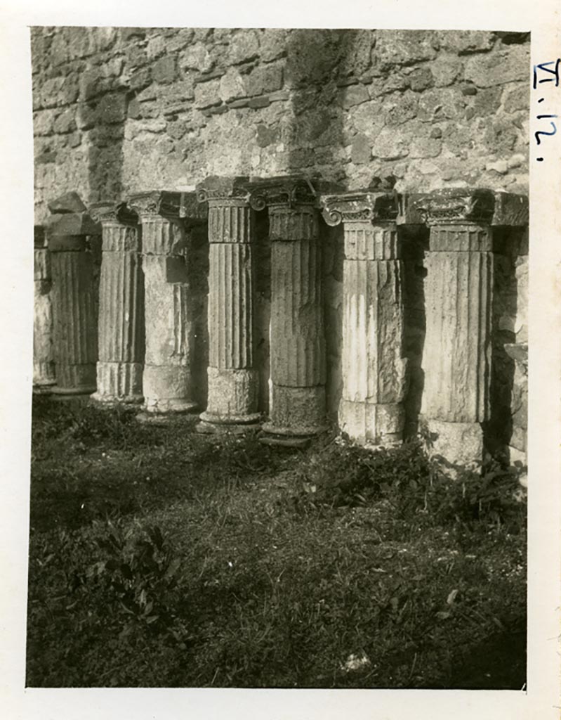 VI.12.2 Pompeii. pre-1937-39. Remains of columns and capitals against east wall of rear peristyle.
Photo courtesy of American Academy in Rome, Photographic Archive. Warsher collection no. 1422.