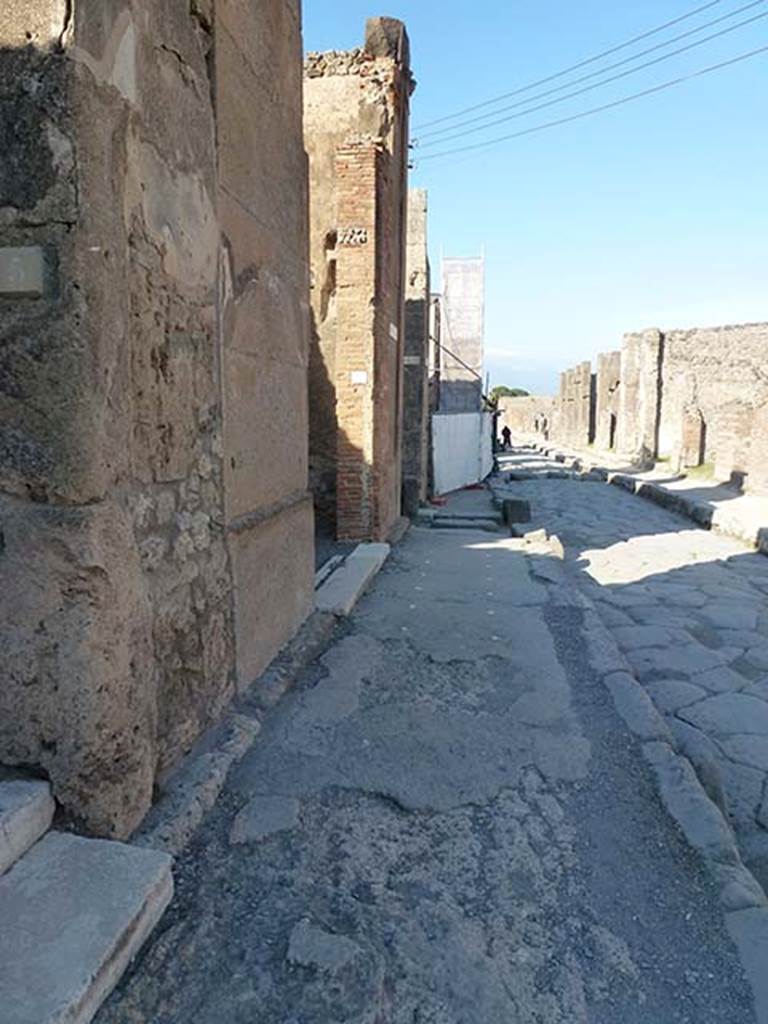 VI.12.6 Pompeii. June 2012. Looking east along pavement outside VI.12.5 and VI.12.6 (centre). Photo courtesy of Michael Binns.