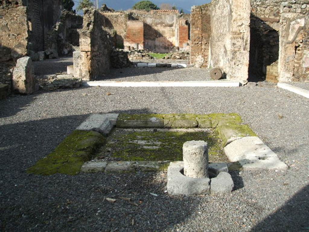 VI.13.2 Pompeii. December 2004. Atrium and impluvium. On 13th September 1943 at 17.00 hours much damage was done when two bombs landed here.
One caused the demolition and destruction of three rooms on the west side of the atrium, with a large part of the perimeter wall onto Vicolo del Fauno. The other damaged another three rooms on the south-east side, together with the perimeter wall on the east side. The south-west of the peristyle was also destroyed together with surrounding areas, including the lararium on the east side.
See Garcia y Garcia, L., 2006. Danni di guerra a Pompei. Rome: L’Erma di Bretschneider. (p. 85)