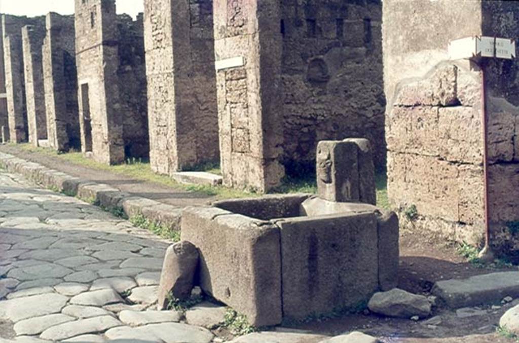 VI.13.7 Pompeii, behind fountain. January 1977. Looking west along VI.13 on north side of Via della Fortuna. Photo courtesy of David Hingston.