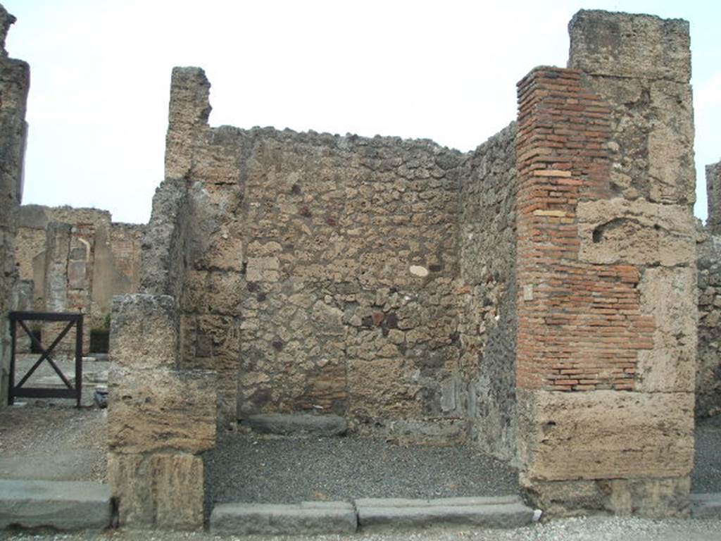 VI.14.13 Pompeii. May 2005. Small shop with blocked doorway in north wall, to atrium of VI.14.12