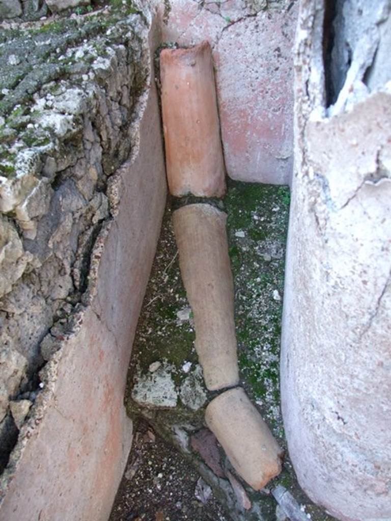 VI.14.22 Fullonica of Balbinus. December 2007. Room 12. Terracotta and lead piping in north west corner of peristyle.