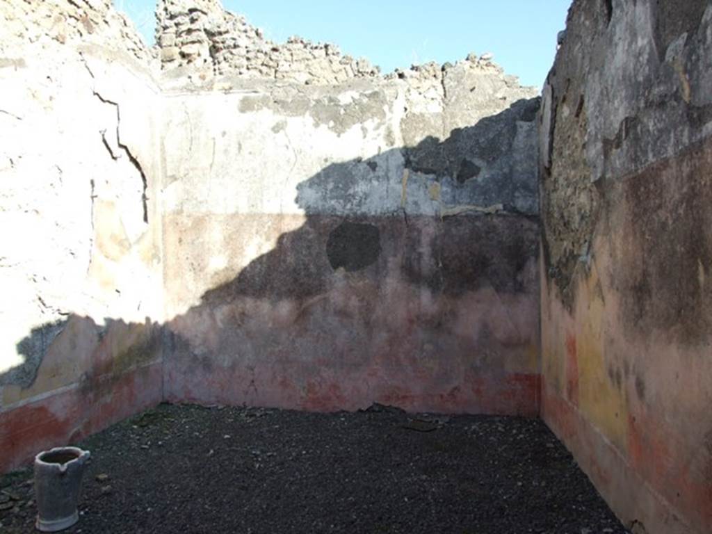 VI.14.22 Pompeii. December 2007. Room 15, east wall of triclinium. According to BdI, on this wall (the back wall) the following paintings were seen upon excavation, beginning from the left (north end): Medallion (0.41 diam) with bust of a Satyr,
Central painting (1.12 x 1.12 but hardly recognisable) on the right of it was a person sitting (0.60 high) with white long robe….,
Medallion vanished.
On the upper part of the wall was the usual fantastique architectural decoration with the following figures – On back wall from the north (left) end: A crowned man sitting on a seat, Nereide on sea-bull, Woman sitting on a seat. See BdI, 1876, (p.24-28)