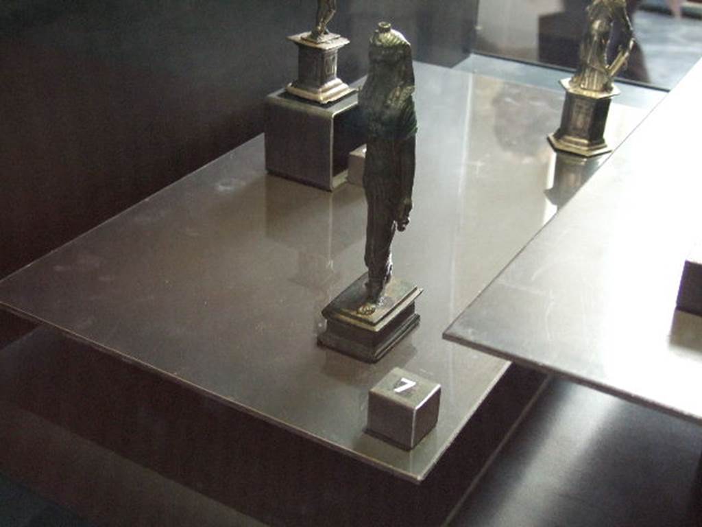 VI.14.27 Pompeii. Found in room “b”. Bronze statuette of Isis found in house.
Now in Naples Archaeological Museum.
