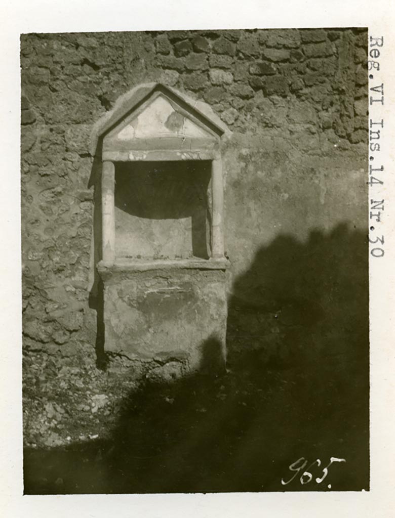 VI.14.30 Pompeii. Pre-1937-39. Aedicula against east wall of garden.
Photo courtesy of American Academy in Rome, Photographic Archive. Warsher collection no. 965.
According to Boyce, against the east wall of the garden stands an aedicula.
Above a solid base, two columns without capitals support a pediment.
In the tympanum is painted a large aquatic bird of reddish colour with wings spread.
It stands upon a black cloth, across its wings lies a black cord ending in a bow-knot, on each side of the bird stands a green marine goat.
The base of the aedicula is black, adorned with a painted garland.
The rear wall within the shrine is hollowed out in the form of a seashell and painted in imitation of one.
In the south wall of the same garden is a niche with projecting floor and vaulted ceiling.
Its walls are adorned with painted plants, flowers and birds.
We can only speculate on the purpose of this niche.
Presumably the aedicula is the lararium, the niche probably contained a figure of primarily decorative character.
See Boyce G. K., 1937. Corpus of the Lararia of Pompeii. Rome: MAAR 14. (p.53, no.203, and Pl. 35,1)
According to Giacobello, the painted decoration on the aedicula and architecture has disappeared, leaving only the stone podium and the niche.
The wall was decorated with a rich garden painting.
Regarding the niche on the south wall of garden, originally painted with flowers, plants and birds, today disappeared, only the red plaster remains.
See Giacobello, F., 2008. Larari Pompeiani: Iconografia e culto dei Lari in ambito domestico. Milano: LED Edizioni. (p.275)