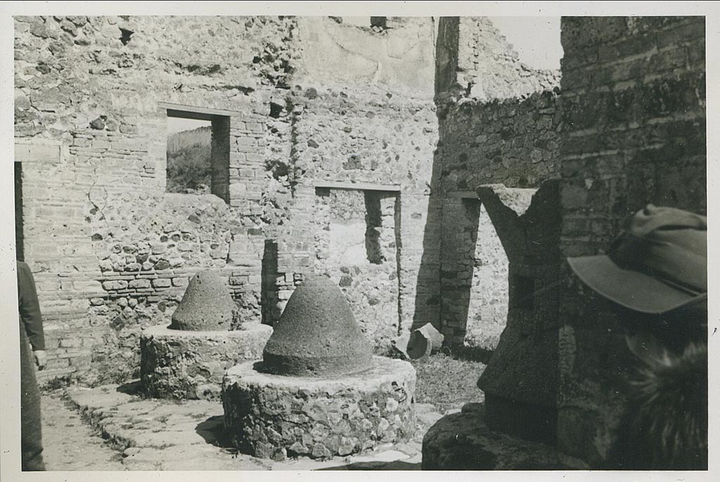 VI.14.32 Pompeii. March 1939.
Looking north-east across mills towards room on east side of entrance doorway, and doorway connecting to VI.14.30, in centre right.
Photo courtesy of Rick Bauer.
