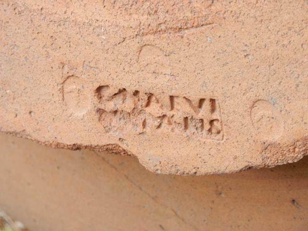 VI.14.35 Pompeii. May 2017. Detail of embossed stamp on large terracotta pot on east side of doorway. Photo courtesy of Buzz Ferebee.