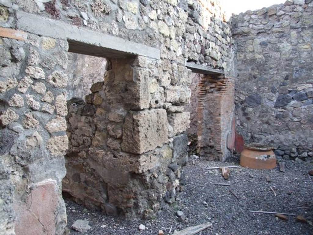 VI.14.35 Pompeii. December 2007. Two doorways in east wall.
On the left is the doorway to the kitchen and latrine, a wooden staircase at the side of the kitchen led to the upper floor. On the right, the doorway to a room for clients.