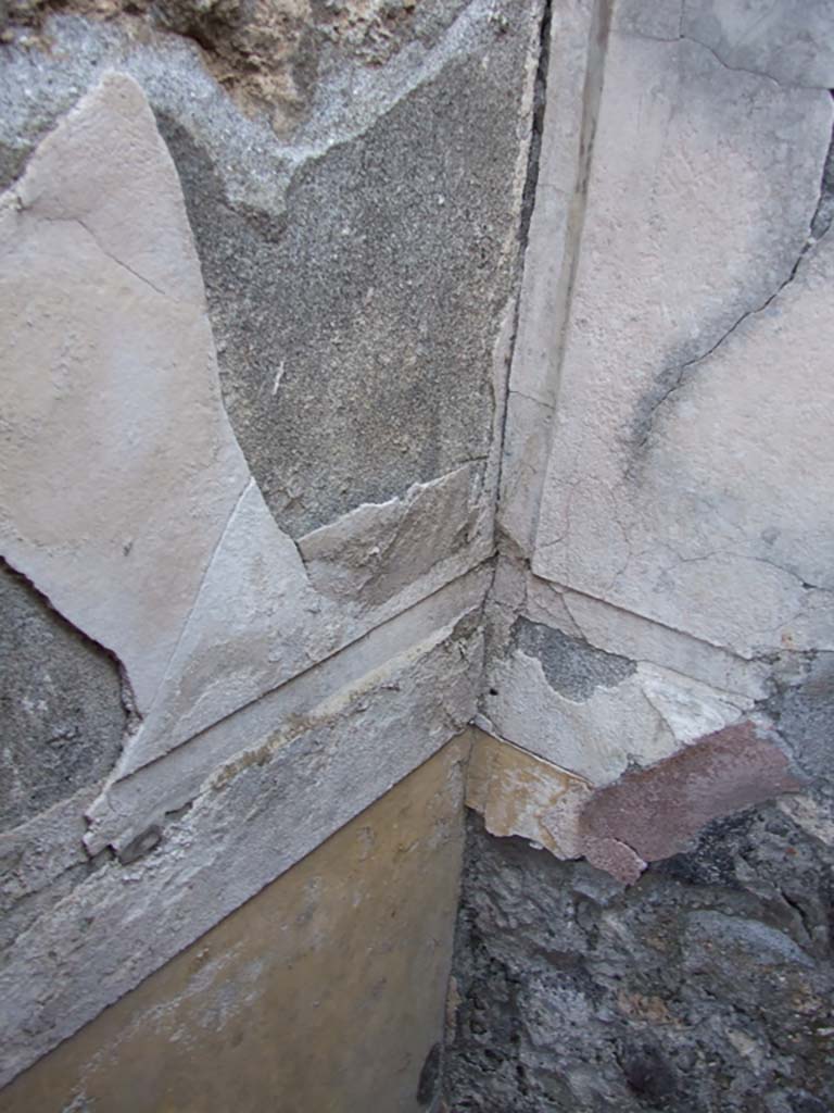 VI.14.43 Pompeii. December 2007. Room 8, north-east corner.
According to Bragantini, the dado was yellow topped with stucco.
The middle zones of the walls were white.
See Bragantini, de Vos, Badoni, 1983. Pitture e Pavimenti di Pompei, Parte 2. Rome: ICCD. (p.300, ambiente ‘6’)