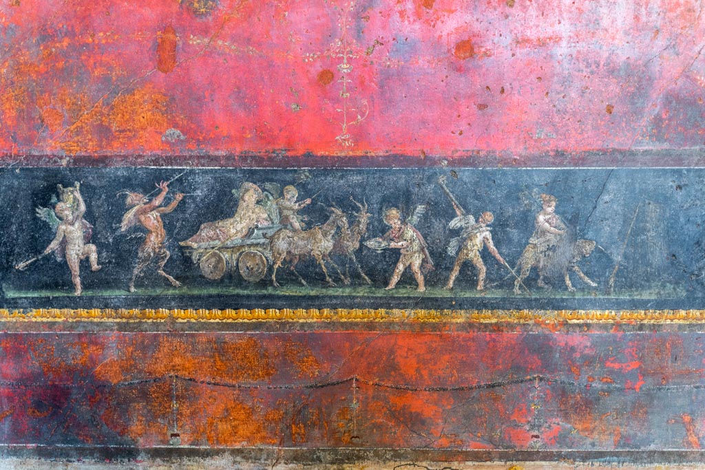 VI.15.1 Pompeii. March 2023.
Lower north wall in north-west corner with painting of cupids celebrating a festival in honour of Bacchus. Photo courtesy of Johannes Eber