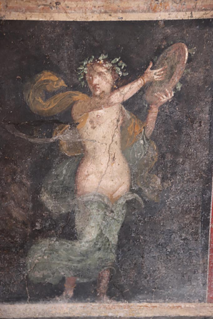 VI.15.1 Pompeii. October 2023.
Panel in zoccolo towards west end of north wall, with standing female figure of a Bacchante.
Photo courtesy of Klaus Heese.